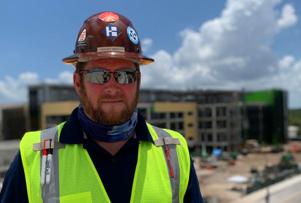 澳门足彩app's Nathan Faloon standing on a jobsite.