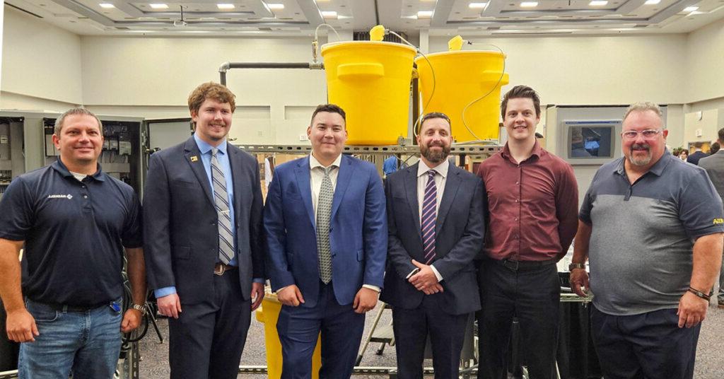 UNF Process Skid team members pose in front of their senior design project. From left are Greg Kline of Vega Americas; Daniel Fowler, Electrical; Adrian Hoover, Mechanical, Bryce Lovelace, Mechanical; Lake Miller, Electrical; and 澳门足彩app’s Christian Beckman.